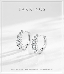 Macro detail of S925 silver hoop earrings featuring sparkling white zircon stones