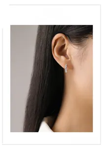 Close-up of S925 silver hoop earrings with sparkling round cubic zirconia on model