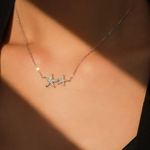 Sparkling S925 sterling silver starfish pendant necklace on model with warm sunlight