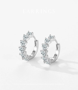 Detailed close-up of S925 sterling silver hoop earrings with heart-cut crystals