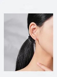 Close-up of model wearing S925 sterling silver hoop earrings with micro-pave diamonds