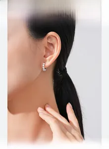 Close-up of S925 sterling silver hoop earrings featuring sparkling heart-shaped zircons
