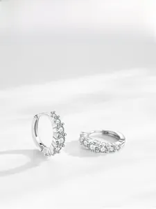 Macro shot of S925 sterling silver hoop earrings with five round sparkling zircons