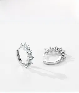 Macro shot of S925 sterling silver hoop earrings featuring five heart-cut cubic zirconia