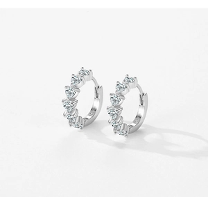 Detailed shot of S925 sterling silver hoop earrings with five sparkling heart-shaped zircons