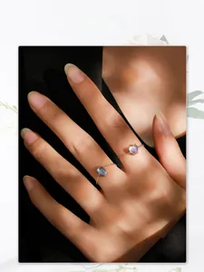 Close-up of S925 sterling silver heart moonstone ring worn by a model in soft shadows