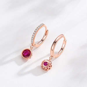 Rose gold plated hoop earrings featuring sparkling pave zircons and round ruby pendants