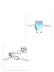 Macro detail of teardrop moonstone and S925 sterling silver hallmark on the chain ring