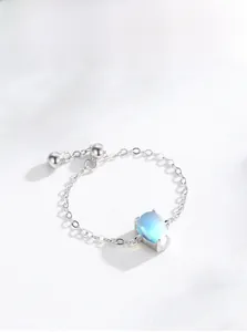 Macro detail of silver drop-shaped moonstone chain ring with adjustable ball pendant