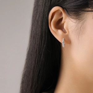 Elegant S925 sterling silver huggie earrings with sparkling round zirconia on female ear
