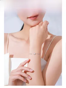 Detailed view of an S925 sterling silver heart bracelet with pavé cubic zirconia on wrist