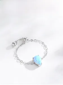 Detail of adjustable S925 silver chain ring featuring a teardrop blue opal in 4-prong setting