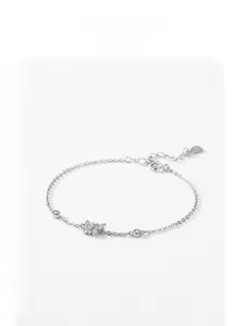 Detail of S925 silver butterfly bracelet with sparkling zircon stones and heart tag