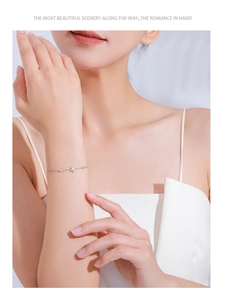 Detailed view of S925 sterling silver star bracelet with zircons worn on female wrist