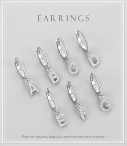 Detailed macro of S925 silver earring hoops with interchangeable A-G diamond letters