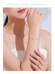 Close-up of S925 silver bracelet featuring a teardrop zircon on a woman's wrist