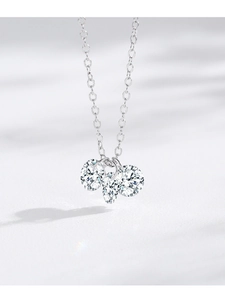 Macro detail of S925 silver necklace with three sparkling clustered round cubic zirconia