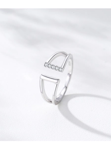Macro shot of S925 sterling silver ring showing geometric u-shape and five small diamonds