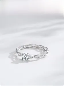 Macro shot of S925 sterling silver ring featuring a twisted band and a sparkling round solitaire