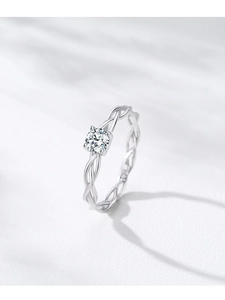 Macro detail of S925 sterling silver ring with woven band and sparkling round cubic zirconia
