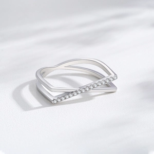 S925 sterling silver crisscross ring with micro-pave cubic zirconia on marble background