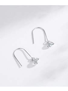 Macro detail of S925 silver hook earrings with sparkling teardrop-shaped zircons