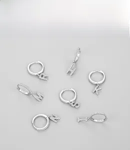 Close-up of S925 sterling silver hoop earrings with diamond-set alphabet letter charms