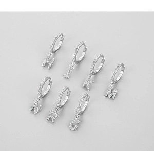 Close-up of S925 sterling silver alphabet earrings with sparkling pave zircon settings