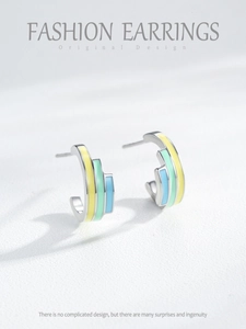 Macro detail of S925 silver U-shaped earrings with colorful enamel stripes