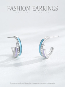 Detail of silver C-shape earrings with blue purple enamel and micro zircon inlay