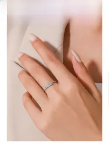 Macro shot of S925 silver ring with blue enamel and micro-pave diamonds on model hand