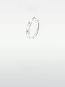 Detailed macro view of S925 sterling silver ring with three pink gemstones and engraving