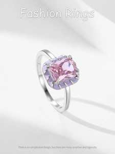 Detailed macro view of silver ring with pink rectangular stone and lilac enamel border