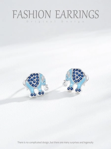 Macro detail of elephant stud earrings with blue enamel and sparkling zircon stones