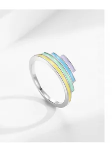 Detail showing colorful enamel layers in yellow, green, blue and purple on a silver ring