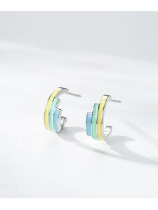 Macro view of C-shaped S925 silver earrings with yellow, green, and blue enamel stripes