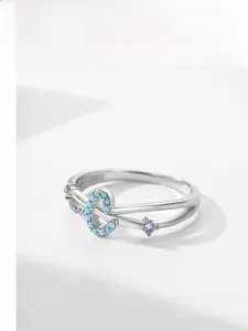 Detail of S925 silver ring featuring blue circular bead and purple star gemstone