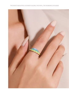 Macro shot of S925 sterling silver ring with colorful rainbow enamel layers on model finger