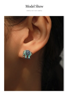 Detailed close-up of S925 silver elephant stud earrings with blue enamel and crystals
