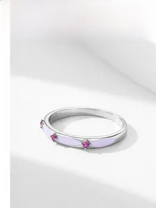 Detail of S925 sterling silver ring with purple enamel and three pink gemstones