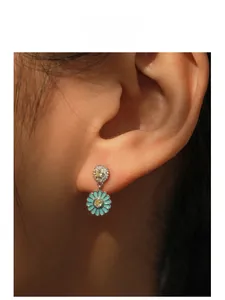 Close-up of S925 silver sunflower earrings with blue enamel and yellow zircon on model