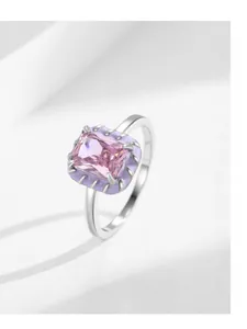 Macro shot of rectangular pink gemstone ring with purple enamel and polished silver band