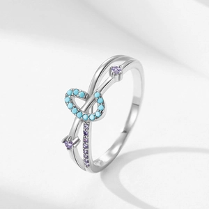 S925 silver cross ring with turquoise heart and purple zircons on light gray background