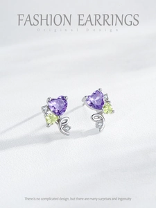 Detailed shot of S925 sterling silver heart earrings with purple gemstone and pavé diamonds