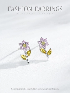 Macro detail of S925 silver flower stud earrings with pink and yellow zircons