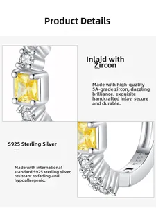 Détail macro de boucles d'oreilles en argent S925 avec zircons jaunes carrés de grade 5A