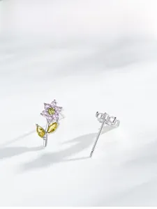 Detailed macro view of S925 silver flower earrings with pink and yellow cubic zirconia