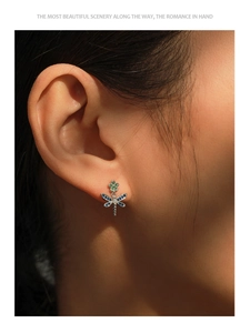 Close-up of S925 silver dragonfly earrings with rainbow cubic zirconia on female model