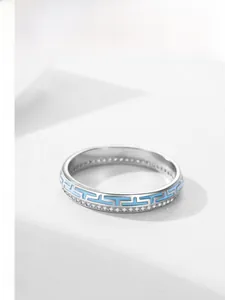 Macro detail of silver ring featuring light blue enamel and micro-pave zircon stones