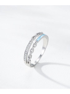 Macro shot of silver S925 chain ring featuring blue enamel and sparkling zircon accents